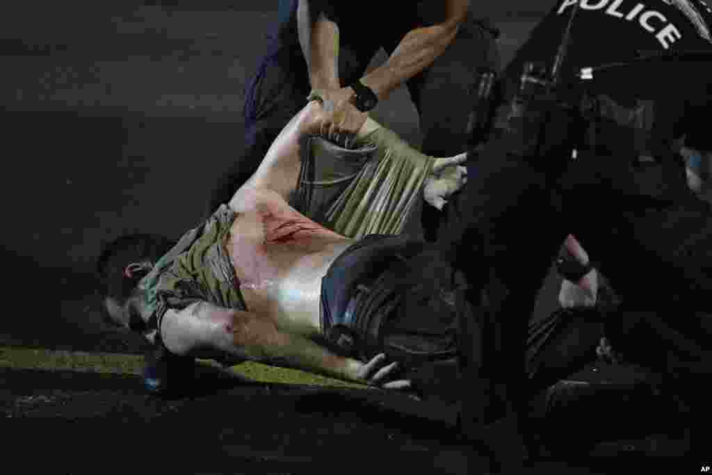 An injured demonstrator is dragged by police for detainment during a protest of plans by Netanyahu&#39;s government to overhaul the judicial system, in Tel Aviv, July 24, 2023.