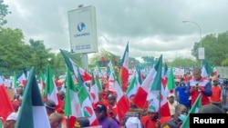 FILE - Members of the Nigerian Labour Union protest against fuel price hikes and rising costs in Abuja, Nigeria, Aug. 2, 2023. 