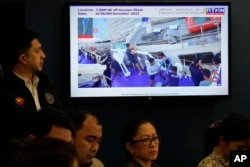A video presentation shows a Philippine coast guard personnel assisting a Philippine supply ship after it was damaged by water cannons from a Chinese coast guard vessel during a press conference, Dec. 11, 2023 in Manila.