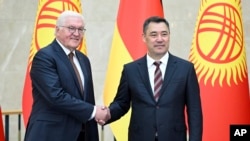 Kyrgyzstan's President Sadyr Japarov, right, and German President Frank-Walter Steinmeier are pictured in Bishkek, Kyrgyzstan, June 22, 2023. (Kyrgyzstan President's Press Office via AP)