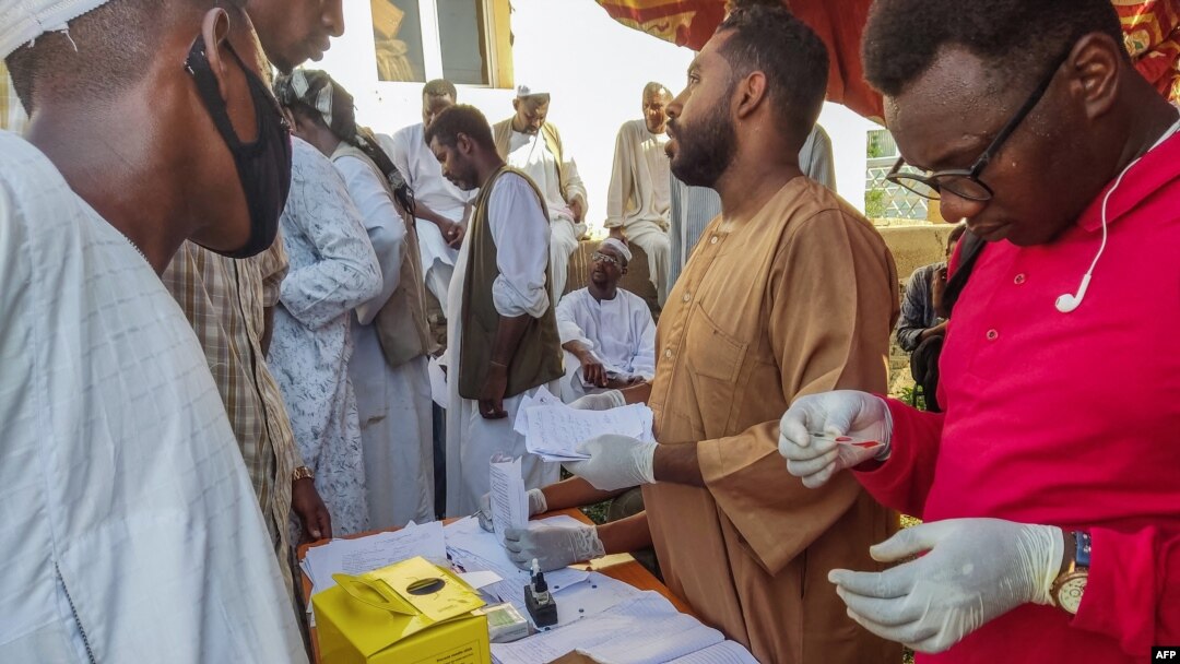 People queue at a medical laboratory to get tested for dengue fever in the eastern Gedaref state of Sudan, Sept. 22, 2023.