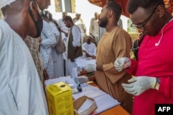 People queue at a medical laboratory to get tested for dengue fever in the eastern Gedaref state of Sudan, Sept. 22, 2023.