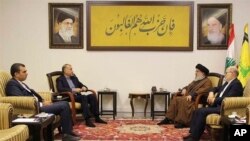 Iran's Foreign Minister Hossein Amirabdollahian, second left, speaks with Lebanese Hezbollah leader Sayyed Hassan Nasrallah, second right, in Beirut, Lebanon, Nov. 23, 2023. (Iranian Foreign Ministry via AP)