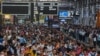 People wait for their train on platforms at the Chhatrapati Shivaji Terminus (CST) railway station Mumbai, India, April 19, 2023.