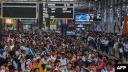 People wait for their train on platforms at the Chhatrapati Shivaji Terminus (CST) railway station Mumbai, India, April 19, 2023.