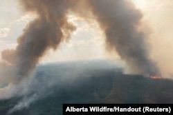 Smoke rises from Internal hotspots flaring up in the Kimiwan wildfire complex in Northern Sunrise County, Alberta, Canada, June 24, 2023.
