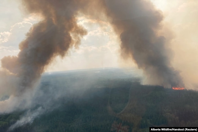 Smoke rises from Internal hotspots flaring up in the Kimiwan wildfire complex in Northern Sunrise County, Alberta, Canada, June 24, 2023.