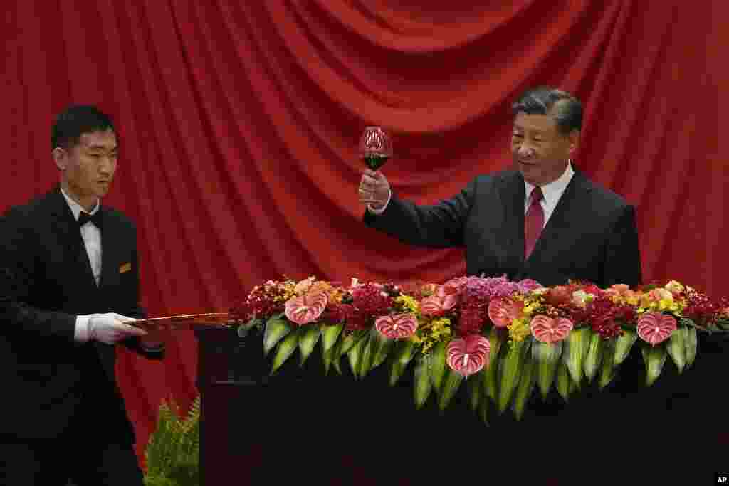 Chinese President Xi Jinping makes a toast after delivering his speech at a dinner marking the 74th anniversary of the founding of the People's Republic of China at the Great Hall of the People in Beijing.