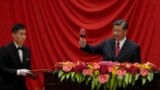 Chinese President Xi Jinping makes a toast after delivering his speech at a dinner marking the 74th anniversary of the founding of the People's Republic of China at the Great Hall of the People in Beijing.