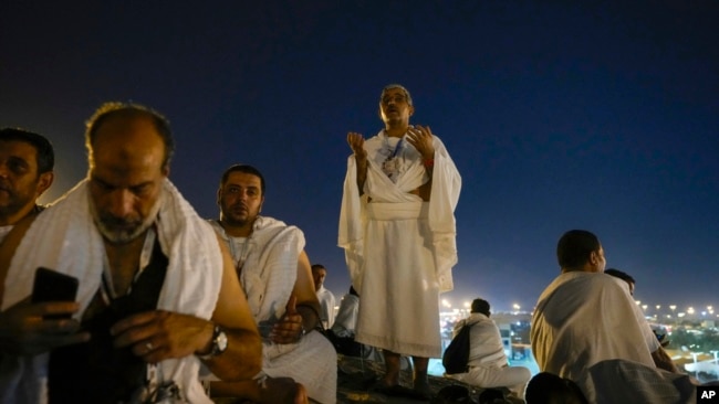 Muslim pilgrims gather at top of the rocky hill known as the Mountain of Mercy, on the Plain of Arafat, during the annual Hajj pilgrimage, near the holy city of Mecca, Saudi Arabia, June 15, 2024.