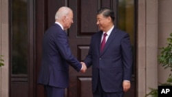 U.S. President Joe Biden greets China's President Xi Jinping at the Filoli estate in Woodside, California, Nov. 15, 2023, on the sidelines of the Asia-Pacific Economic Cooperation forum. (Doug Mills/The New York Times via AP)