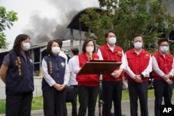 Taiwan's President Tsai Ing-wen speaks near the scene of a factory fire at golf ball manufacturer Launch Technologies Co. in the southern county of Pingtung in Taiwan, Sept. 23, 2023. (Pingtung County Government via AP)