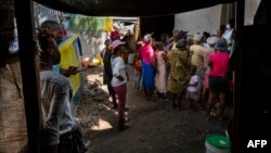 A mental health worker speaks to a small crowd of internally displaced people at a local church in the Delmas district of Port-Au-Prince, Haiti, June 11, 2024.