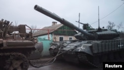 A tank is towed through a road, amid Russia's invasion of Ukraine, near the bombed-out eastern Ukrainian city of Bakhmut, in the eastern Donetsk region, Ukraine, March 29, 2023.