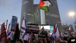 Demonstrators wave the Israeli and Palestinian flags during a protest against the prime minister's plans to overhaul the judicial system, in Tel Aviv, Israel, July 22, 2023.