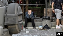 A man reacts as rescuers and volunteers work to rescue people from under the rubble after a missile strike hit a restaurant in Kramatorsk, eastern Ukraine, June 27, 2023.