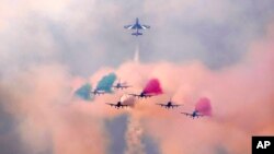 Frecce Tricolori (Tricolor Arrows), the Italian Air Force aerobatic display team, perform during the opening day of the Dubai Air Show, United Arab Emirates. (AP Photo/Kamran Jebreili)