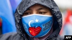 FILE - An ethnic Uyghur demonstrator takes part in a protest against China near the Chinese Consulate in Istanbul, on Oct. 1, 2023, China's National Day.