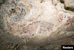 A painting created at least 51,200 years ago in the limestone cave of Leang Karampuang in the Maros-Pangkep region of the Indonesian island of Sulawesi. (BRIN/Handout via REUTERS)