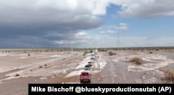 In this photo provided by Mike Bischoff, vehicles are lined up after flash flooding along Highway 42 near Willard, New Mexico, June 19, 2024.