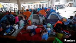 Haitian asylum seekers set up camp in an abandoned gas station while they wait to attempt to cross into the U.S. by an appointment through the Customs and Border Protection app at a makeshift camp, in Matamoros, Mexico, June 21, 2023.