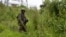 FILE - An M23 rebel looks on in Kibumba in eastern Democratic Republic of the Congo, Dec. 23, 2022. The military spokesman for the Rwandan-backed M23 rebel group has been sanctioned by the U.N. Security Council. 