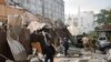 A police officer and a rescue worker walk in front of a restaurant destroyed by a Russian attack in Kramatorsk, Ukraine, June 27, 2023. (National Police of Ukraine via AP)