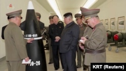 A screen grab shows North Korean leader Kim Jong Un inspecting nuclear warheads at an undisclosed location in this undated still image used in a video. 