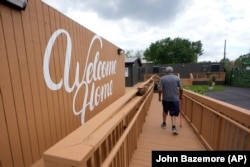 Otis Johnson walks from his apartment in Atlanta on April 12, 2024. The Melody is a housing complex made from shipping containers and is intended to help house people from Atlanta's homeless population. (AP Photo/John Bazemore)