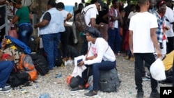 Haitians waiting to board a flight to Nicaragua gather after the government banned all charter flights to Nicaragua, at Toussaint Louverture International Airport in Port-au-Prince, Haiti, Oct. 30, 2023.