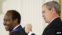 FILE: In this photo taken on November 09, 2005, then-US President George W. Bush presents the Presidential Medal of Freedom, the nation's highest civil award, to Rwandan hotel manager Paul Rusesabagina in the East Room of the White House in Washington