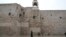 A priest walks by the Church of the Nativity, traditionally believed to be the birthplace of Jesus, on Christmas Eve, in the West Bank city of Bethlehem, Dec. 24, 2023. 