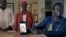 Jacob Mabil, right, speaks while showing a cell phone photo of hie nieces Nyanluak Deng, left, and Anyier Deng during an interview at his home on Wednesday, November 8, 2023, in Haslet, Texas.