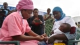 A health worker administers the malaria vaccine Oxford-Serum R21 to a child in Abidjan, Ivory Coast, Monday, July 15, 2024. (AP Photo/Diomande Ble Blonde)