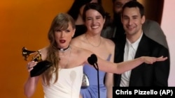 Taylor Swift accepts the award for album of the year for "MIdnights" during the 66th annual Grammy Awards on Sunday, Feb. 4, 2024, in Los Angeles. (AP Photo/Chris Pizzello)