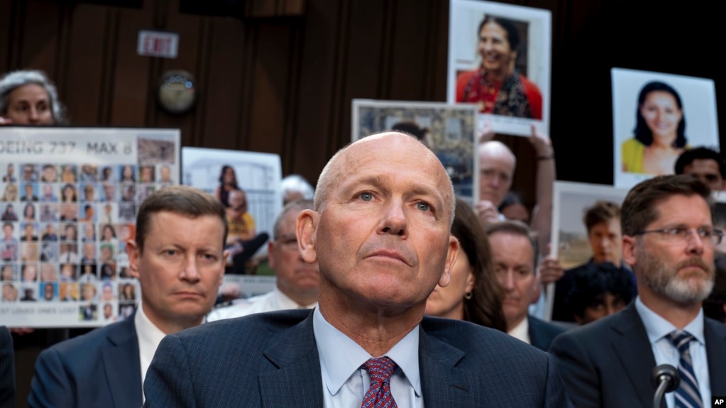 FILE - With protesters in the audience, Boeing CEO Dave Calhoun waits to testify before the Senate Homeland Security and Governmental Affairs Subcommittee on Investigations at the Capitol in Washington, Tuesday, June 18, 2024. (AP Photo/J. Scott Applewhite, File)