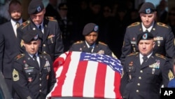 A casket holding the remains of Army Reserve soldier Staff Sgt. William Jerome Rivers is carried from a church after a funeral service Feb. 13, 2024, in Carrollton, Ga.