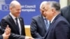 Germany's Chancellor Olaf Scholz (L) shakes hands with Hungary's Prime Minister Viktor Orban as they speak prior to the start of a European Council meeting at the European headquarters in Brussels, on Feb. 1, 2024.