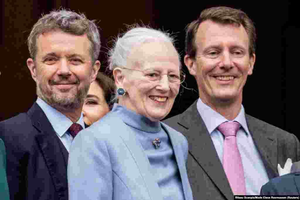 Denmark&#39;s Crown Prince Frederik, Queen Margrethe and Prince Joachim react as the Queen celebrates her 83rd birthday at Amalienborg Castle in Copenhagen.