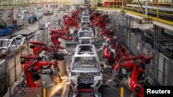 FILE - Robotic arms assemble cars in the production line for Leapmotor's electric vehicles at a factory in Jinhua, Zhejiang province, China, April 26, 2023. (China Daily via Reuters)