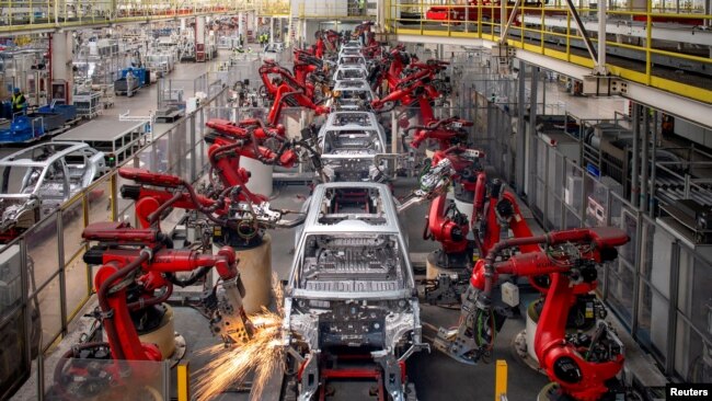 FILE - Robotic arms assemble cars in the production line for Leapmotor's electric vehicles at a factory in Jinhua, Zhejiang province, China, April 26, 2023. (China Daily via Reuters)