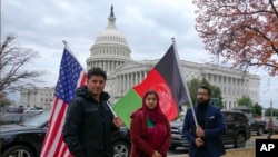 FILE - Demonstrators gather to support new Afghan immigrants, outside of the Capitol, Dec. 8, 2022, in Washington.