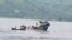 In this video frame grab, a boat sinks in the Congo river outside Kinshasa, Democratic Republic of Congo, Feb. 12, 2024.