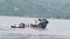 FILE - In this video frame grab, a boat sinks in the Congo river outside Kinshasa, Democratic Republic of Congo, Feb. 12, 2024.