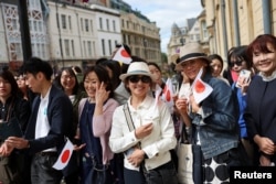 People gather to see Japan's Emperor Naruhito and Empress Masako during the royal couple's state visit to the UK, in Oxford, Britain, June 28, 2024.
