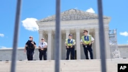 Supreme Court Police officers stand outside the Supreme Court, in Washington, July 1, 2024.