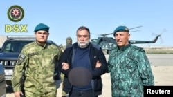 Ruben Vardanyan, a former top official in the separatist ethnic Armenian administration of Nagorno-Karabakh, is detained by Azerbaijan's border service personnel in this picture released Sept. 27, 2023. (State Border Service of Azerbaijan via Reuters)