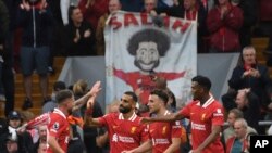 FILE - Liverpool's Mohamed Salah, centre, celebrates with teammates after scoring his side's second goal during the English Premier League soccer match between Liverpool and Brentford at Anfield Stadium, Liverpool, England, Aug. 25, 2024.