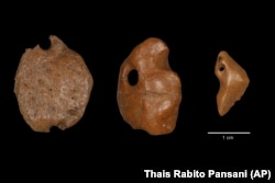 This image provided by researchers shows artifacts made of bony material from a giant sloth discovered at a rock shelter in Brazil, recovered from archaeological layers dated to 25,000 to 27,000 years ago. (Thais Rabito Pansani via AP)