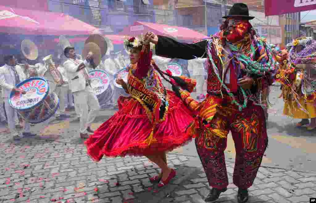 Revelers dance on the closing day of Carnival in La Paz, Bolivia, Feb. 18, 2024. 